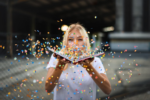 Girl blowing book