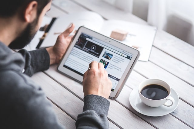 man reading on tablet digital screen